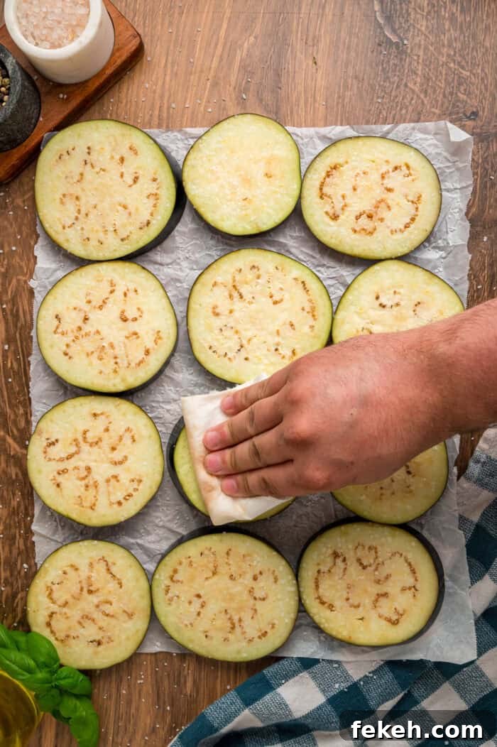 Patting eggplant slices dry Patting eggplant slices dry