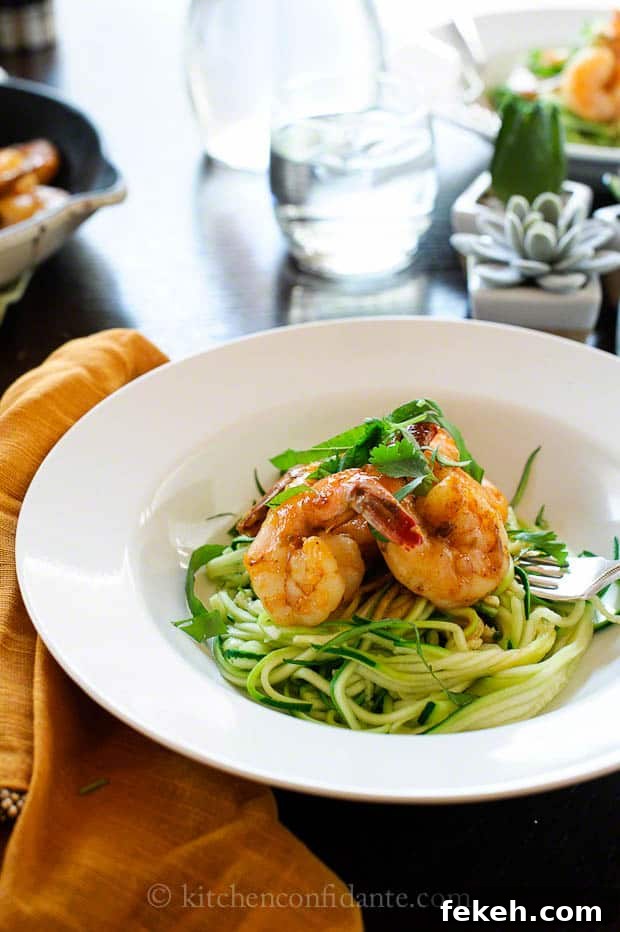 Spicy Shrimp with Zucchini Noodles | Kitchen Confidante | Plate A pasta bowl full of zucchini noodles topped with shrimp.