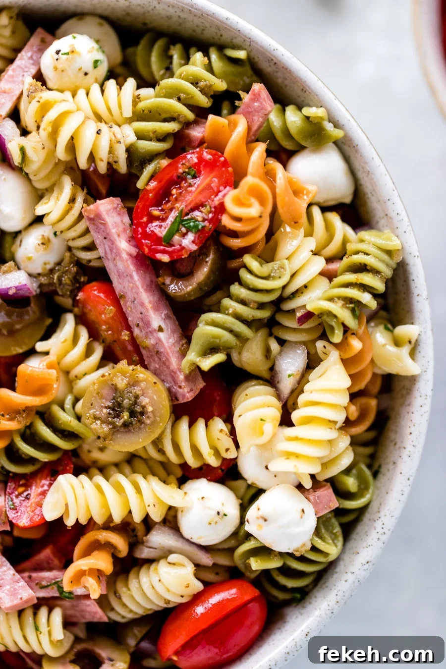 Quick Italian Pasta Salad Recipe for Summer Potlucks 4 ingredients for Italian Pasta Salad in a large glass bowl.