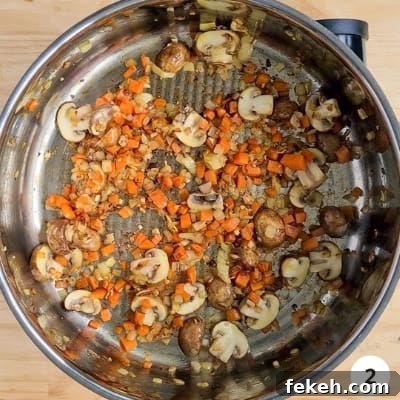 Roasted Pumpkin Vegetarian Bolognese Recipe for Cozy Dinners 5 Mushrooms, diced onions and diced carrots cooking in a pot