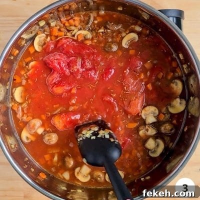 Roasted Pumpkin Vegetarian Bolognese Recipe for Cozy Dinners 6 Simmering a pot of vegetables and stock