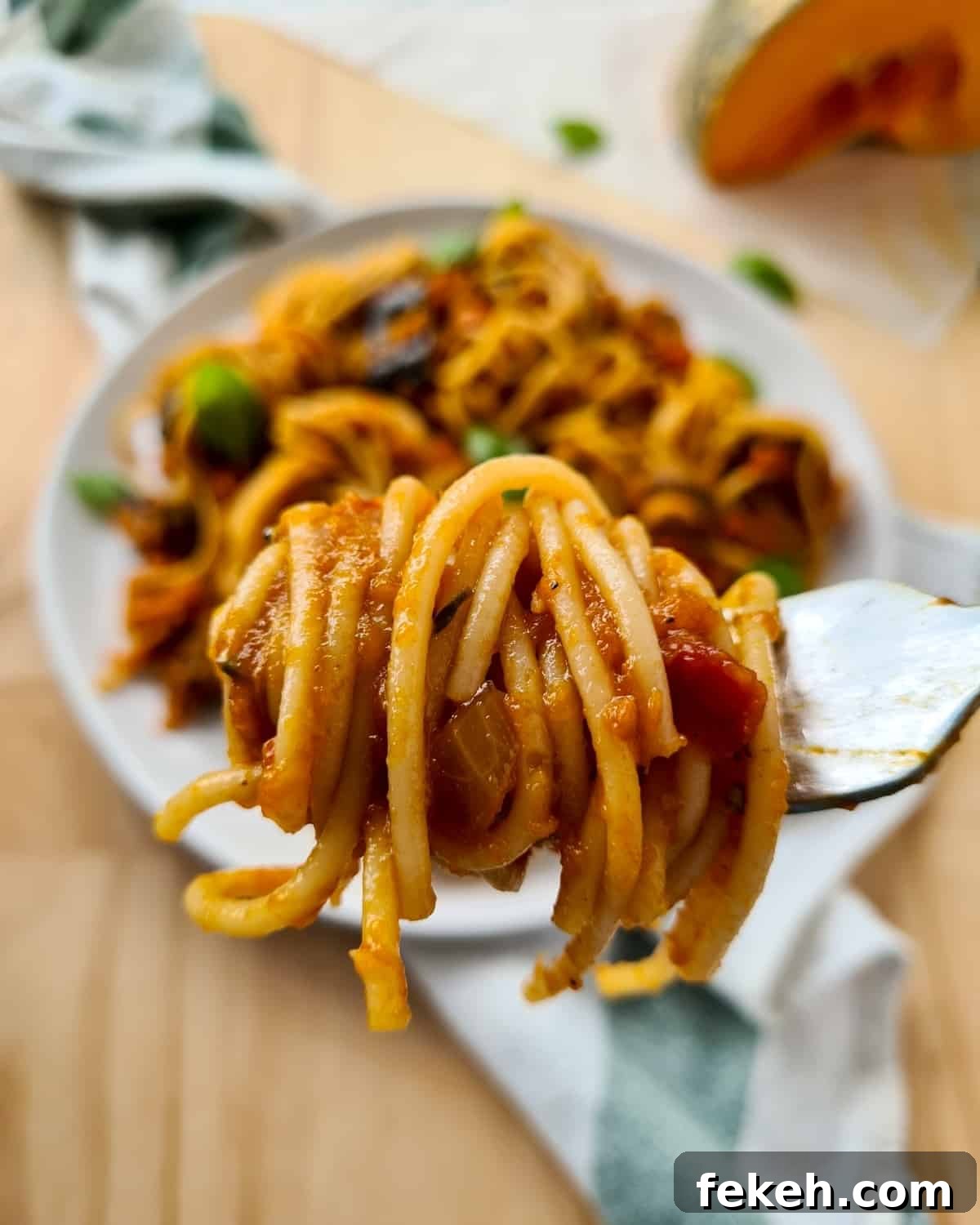 Roasted Pumpkin Vegetarian Bolognese Recipe for Cozy Dinners 9 close up of a fork-ful of spaghetti mixed with vegetarian bolognese