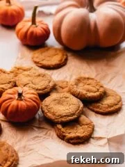 pumpkin spice snickerdoodle cookies on parchment paper