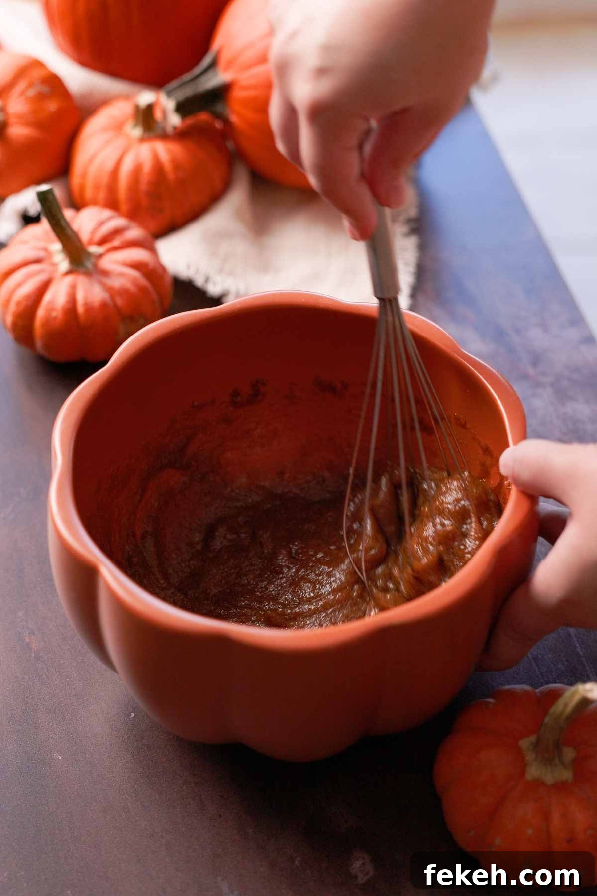 Pumpkin Chocolate Loaf with Spiced Chocolate Chips 5 whisking eggs and sugar with a wire whisk in a pumpkin shaped bowl