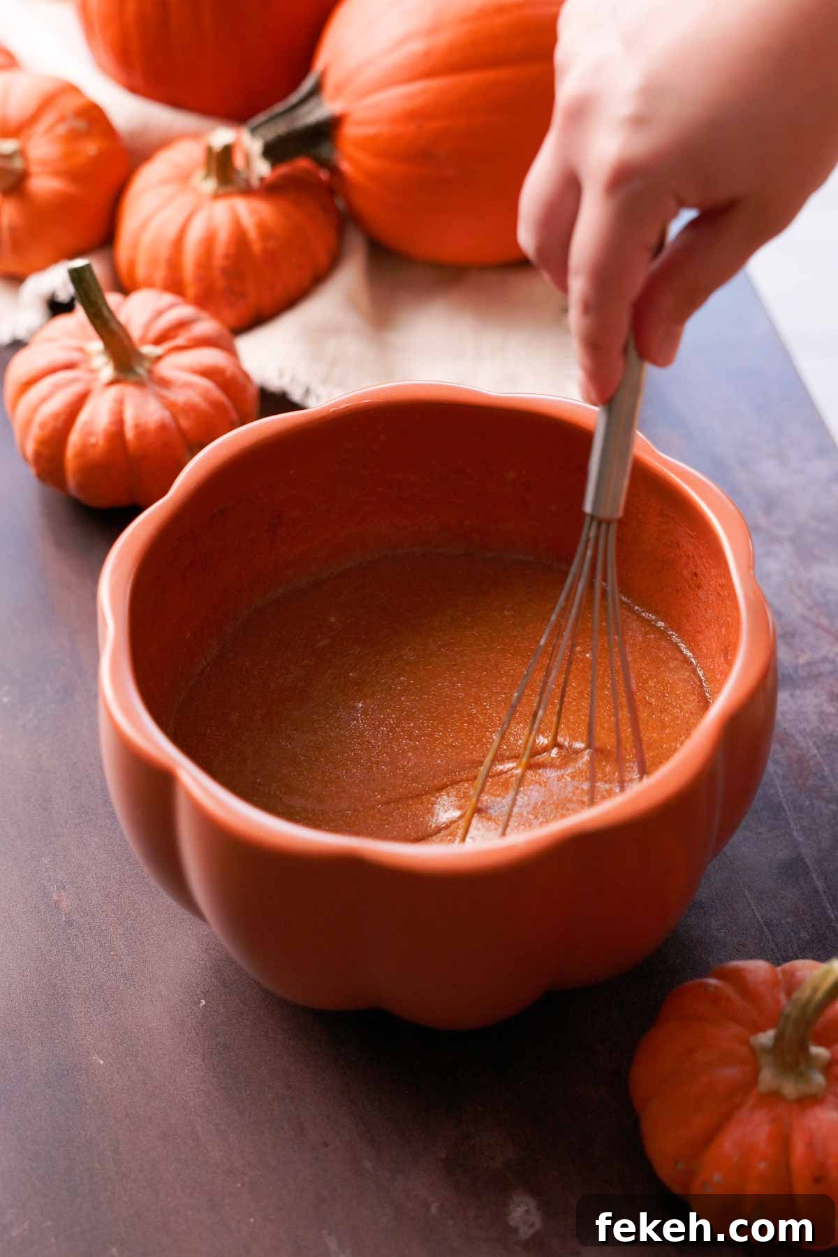 Pumpkin Chocolate Loaf with Spiced Chocolate Chips 6 whisking pumpkin batter wet ingredients in large pumpkin shaped bowl