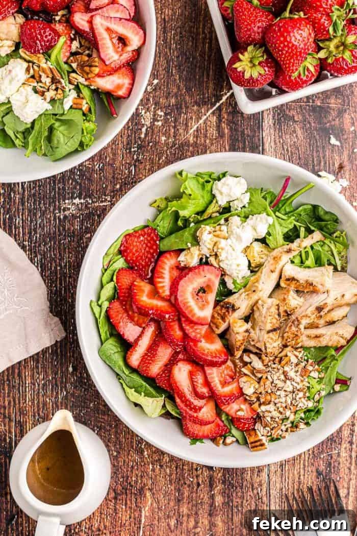 Low-Carb Keto Taco Salad Recipe for Quick Weeknight Meals 15 overhead view of keto strawberry chicken salad next to a bowl of fresh strawberries