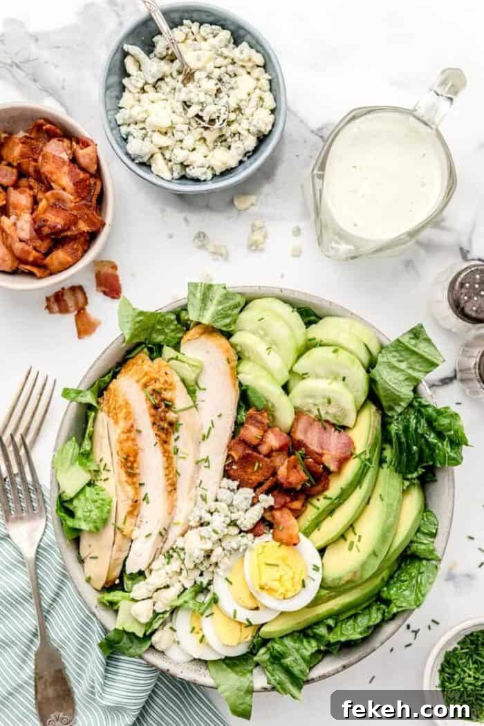 Low-Carb Keto Taco Salad Recipe for Quick Weeknight Meals 17 overhead view of keto cobb salad next to bowls of bacon, cheese, and dressing