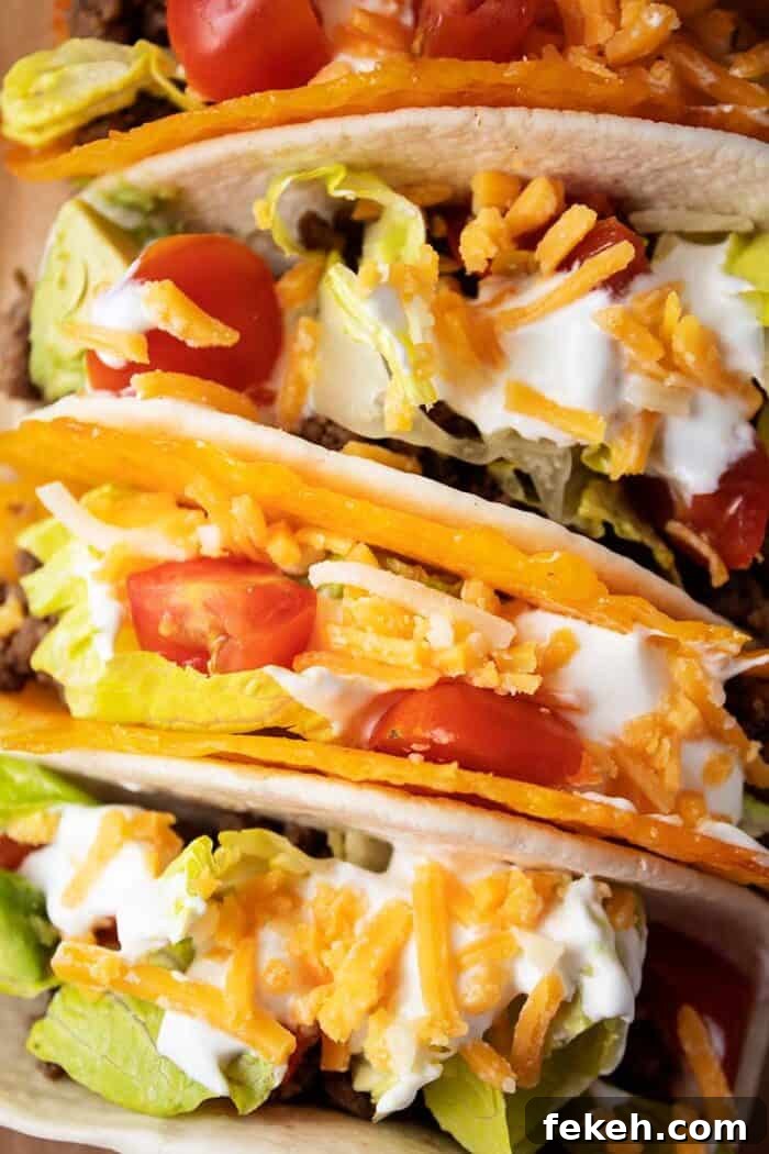 Low-Carb Keto Taco Salad Recipe for Quick Weeknight Meals 5 overhead view of 4 tacos with 2 in cheese shells and 2 in tortillas with meat, lettuce, tomato, cheese and avocado