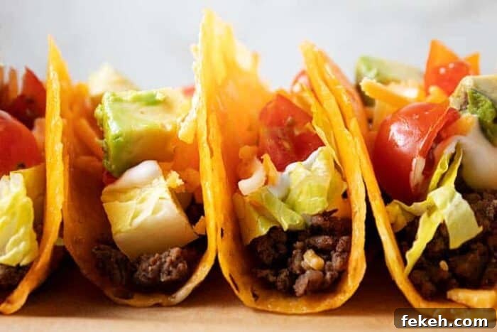 Low-Carb Keto Taco Salad Recipe for Quick Weeknight Meals 9 side view of row of keto tacos inside of cheese shells