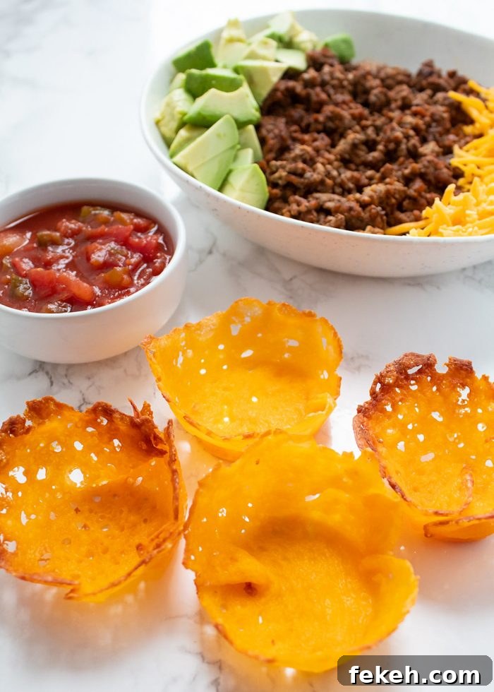 Low-Carb Keto Taco Salad Recipe for Quick Weeknight Meals 10 keto taco cups with various meats and cheeses in the background