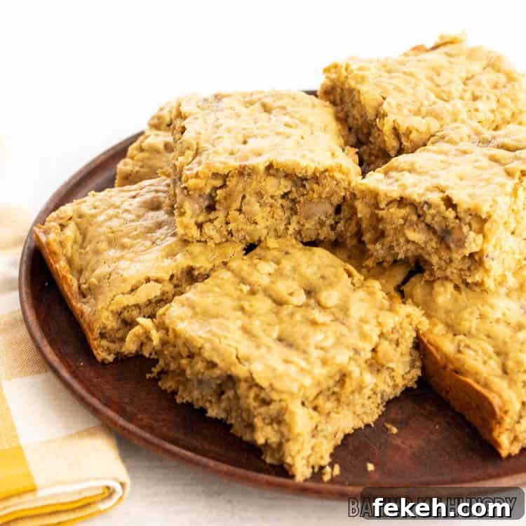 Peanut Butter Banana Oat Oatmeal Bars — Chewy Snack Squares 11 wooden plate with peanut butter banana oatmeal bars