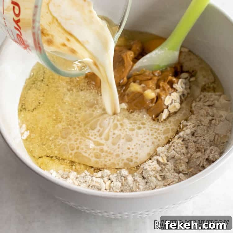 Peanut Butter Banana Oat Oatmeal Bars — Chewy Snack Squares 6 wet ingredients being adding to dry ingredients