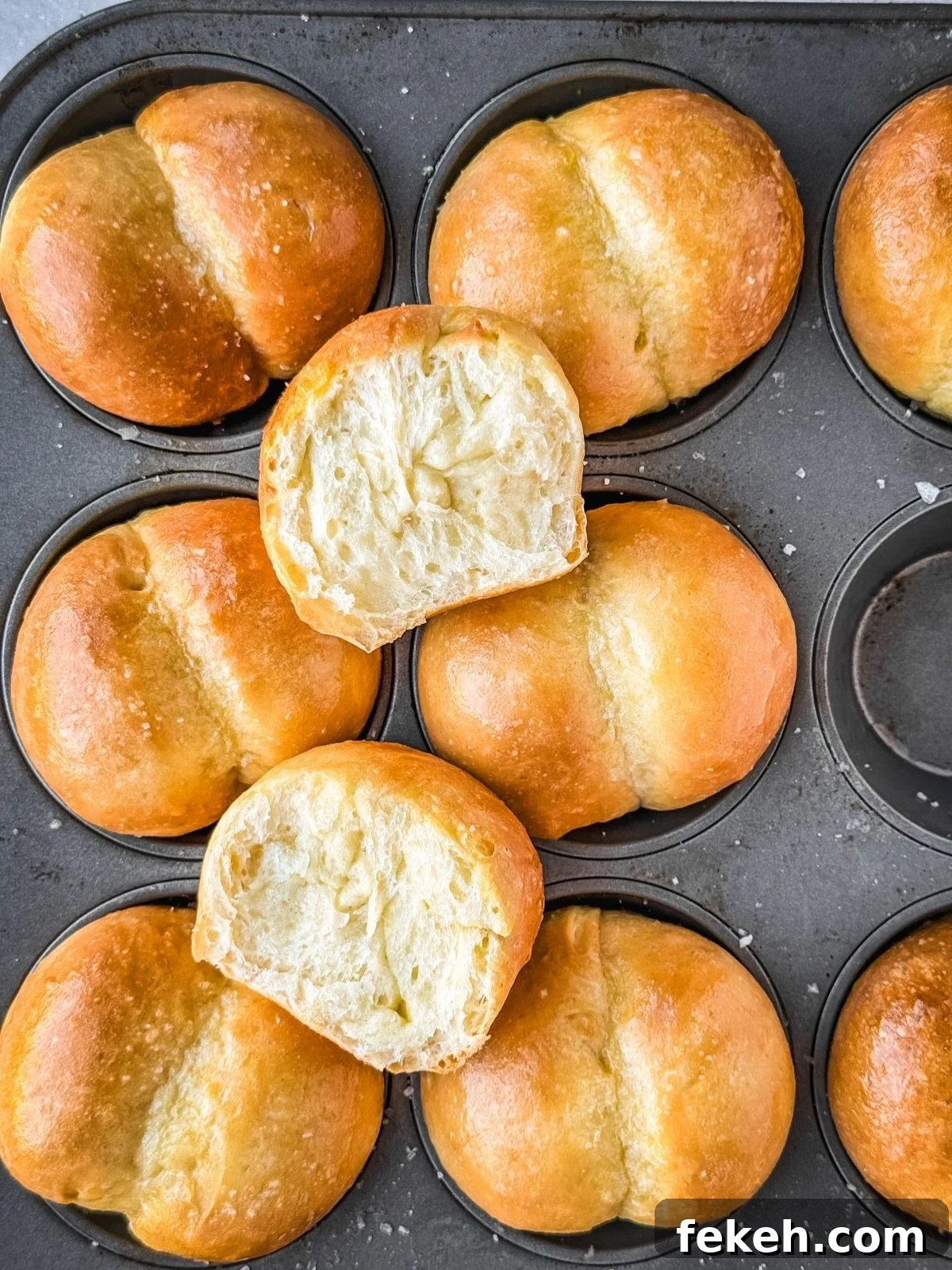 Soft Buttery Double-Cheek Dinner Rolls Recipe 8 Double cheeked buns in a muffin tin showing the cross section of one of the buns.