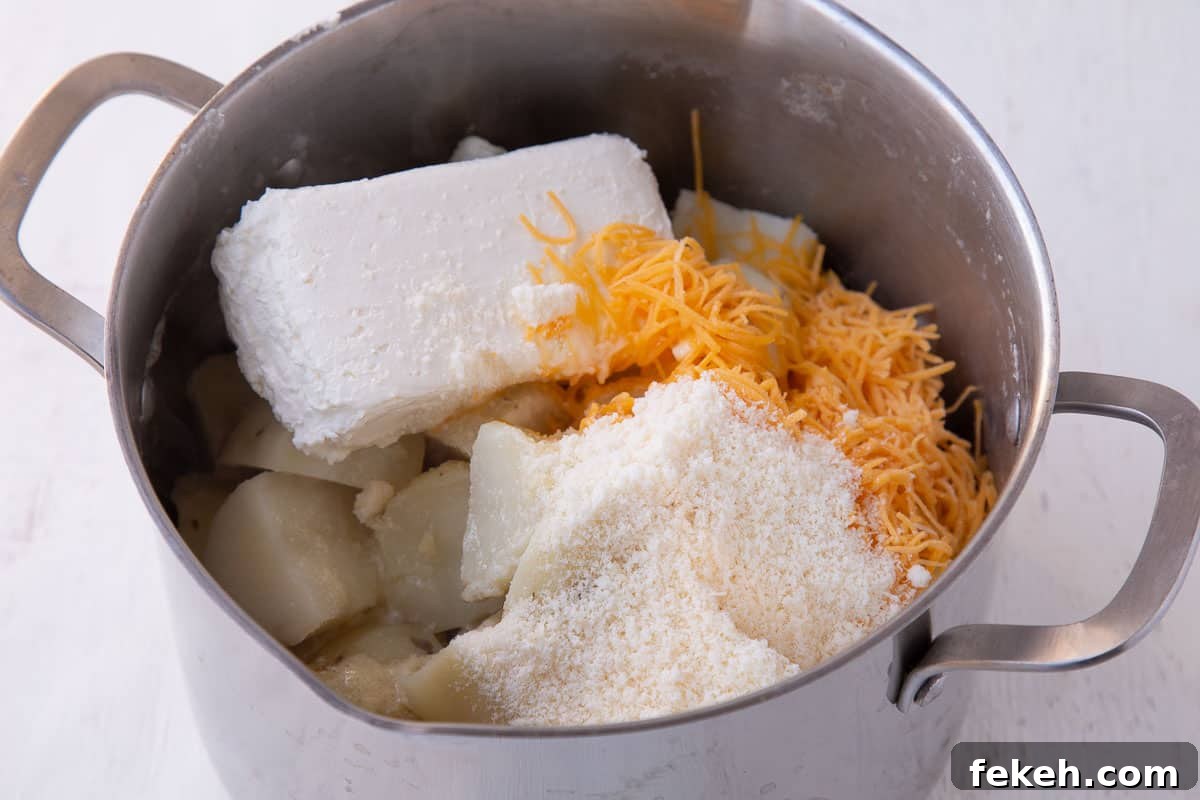 potatoes, cream cheese, cheddar, and parmesan in a large pot.