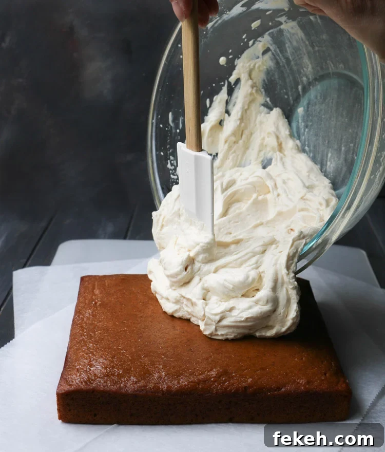 Pumpkin Olive Oil Cake — Eggless, Dairy-Free, Butter-Free Recipe 12 Pouring whipped maple cream cheese frosting onto a square crazy pumpkin olive oil cake