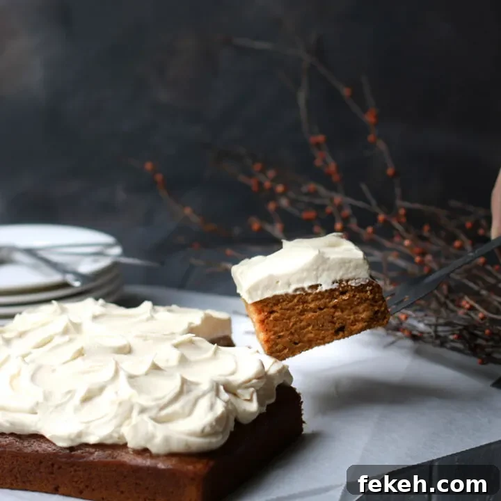 A slice of Crazy Pumpkin Olive Oil Cake being lifted up with a spatula
