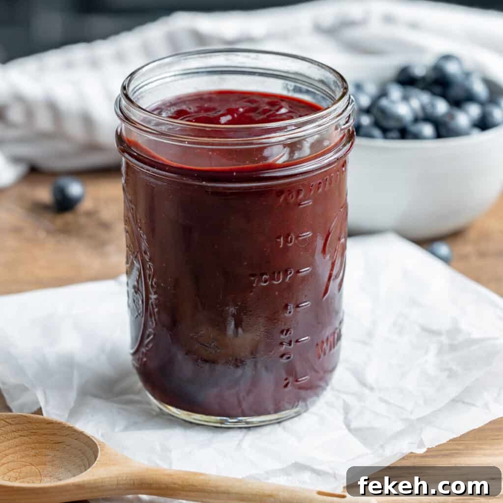 Pineapple Jalapeño Jam Recipe: Sweet-Spicy Preserves Guide 12 BBQ sauce in a mason jar. Blueberries in the background.