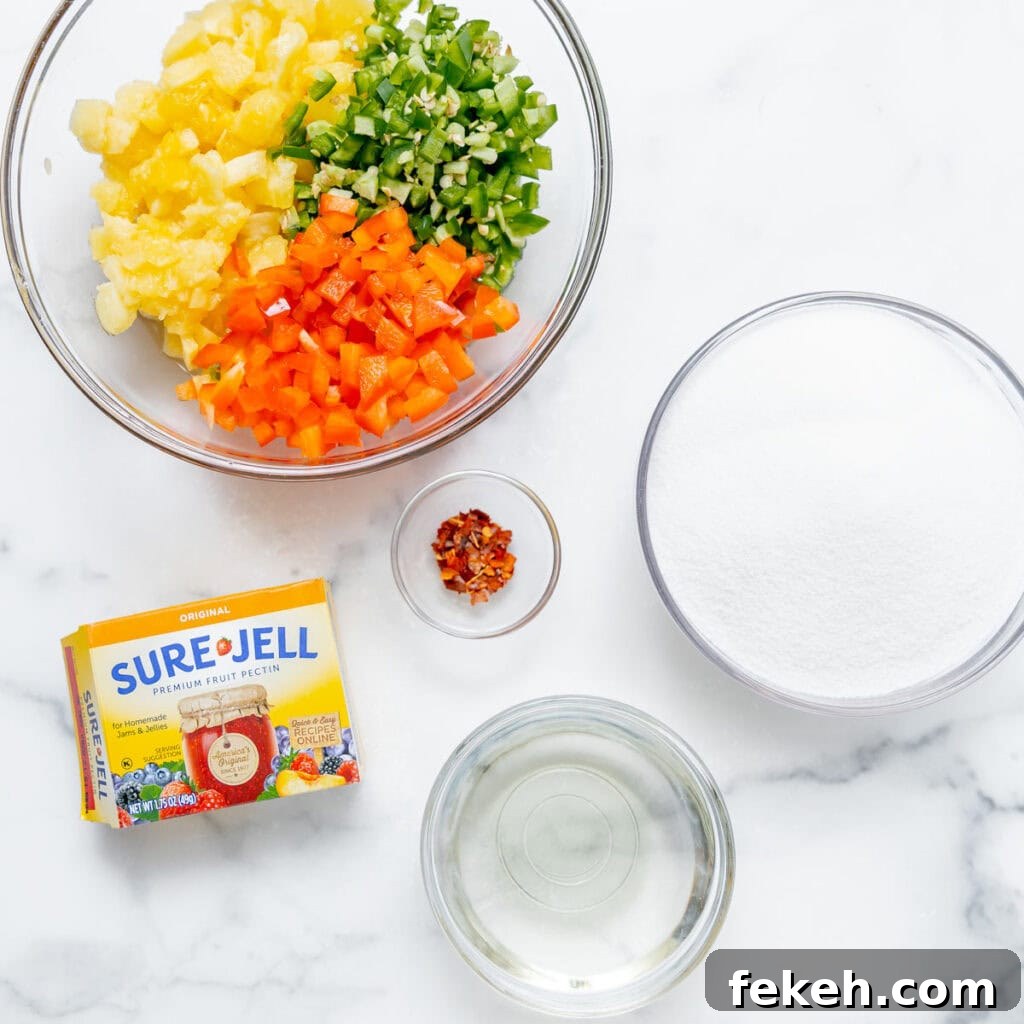 Pineapple Jalapeño Jam Recipe: Sweet-Spicy Preserves Guide 4 Chopped pineapple, jalapenos, and red peppers in a bowl, with bowls of sugar, vinegar, crushed red pepper, and a box of Sure-Jell fruit pectin on a white surface.