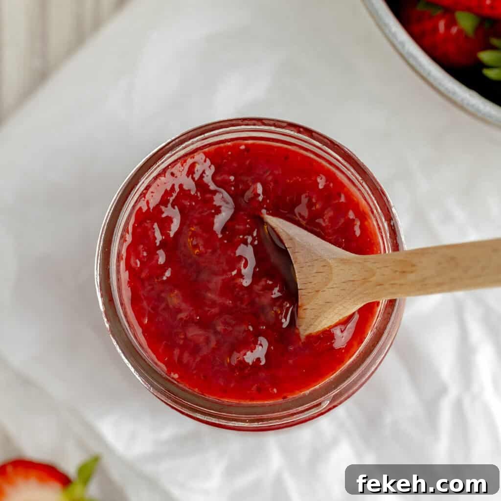 Pineapple Jalapeño Jam Recipe: Sweet-Spicy Preserves Guide 10 A wooden spoon in a jar of jam