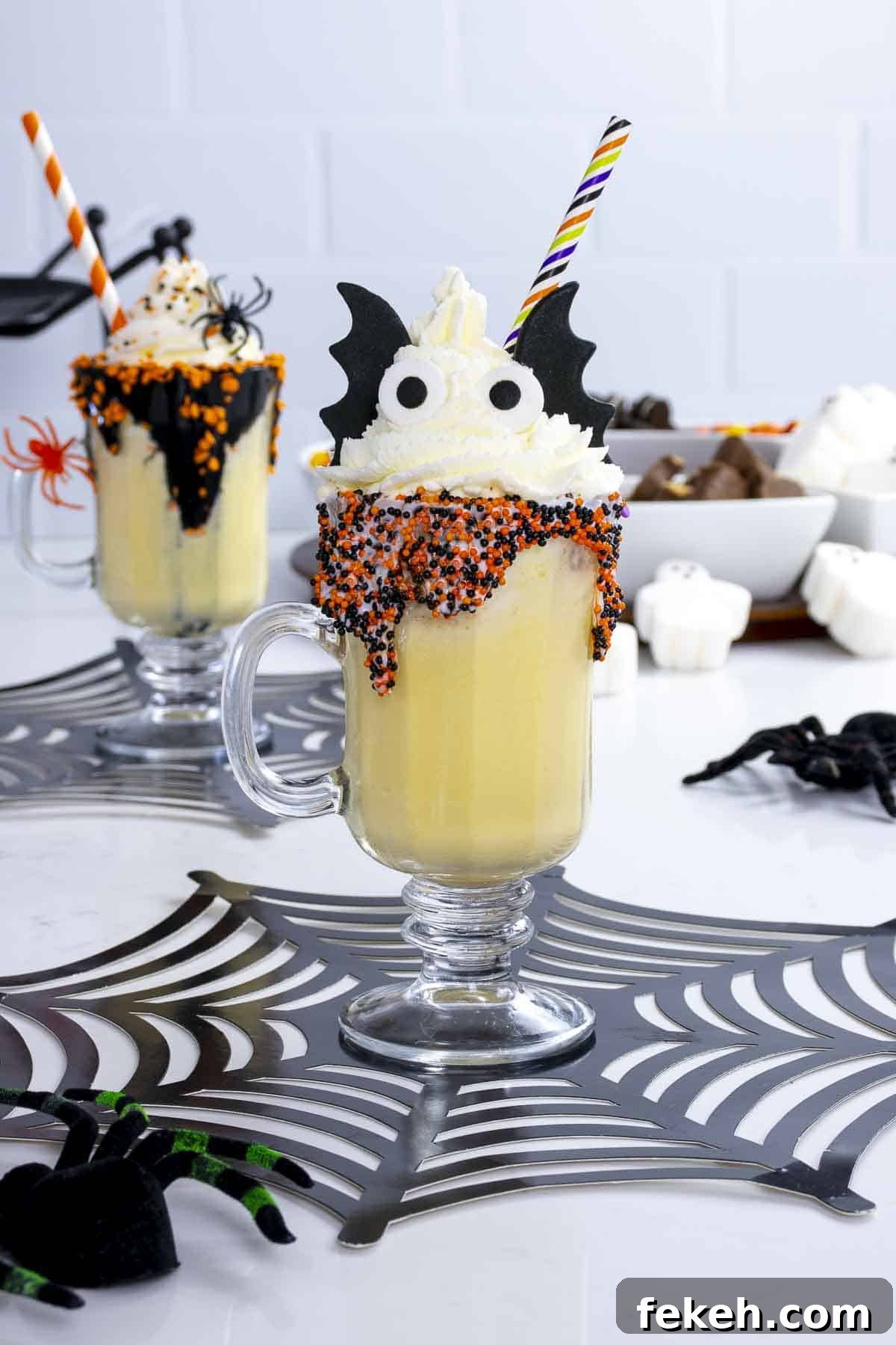 Kids Halloween milkshake on table with bat ears, wings, and a straw.