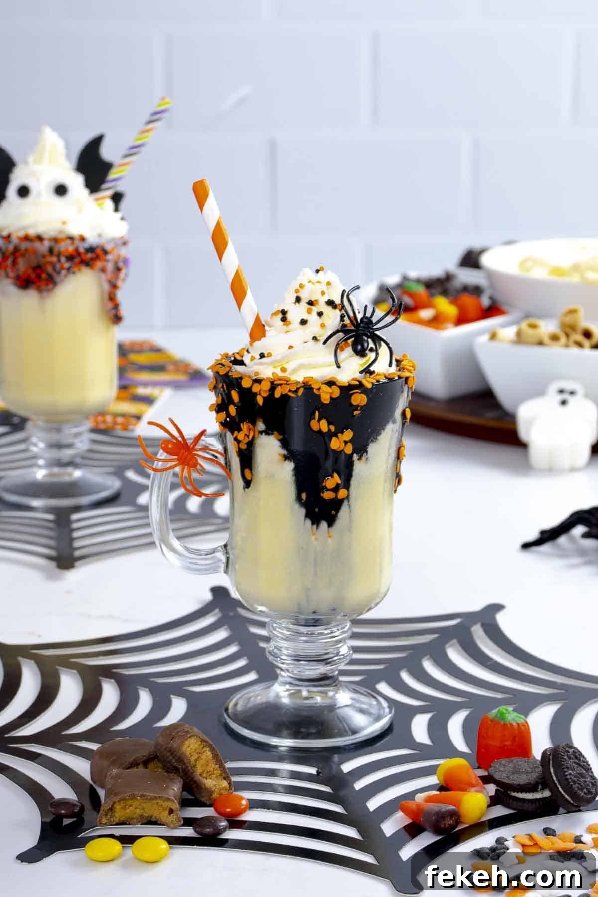 Vanilla milkshake with chocolate sauce and whipped cream and spider decor.