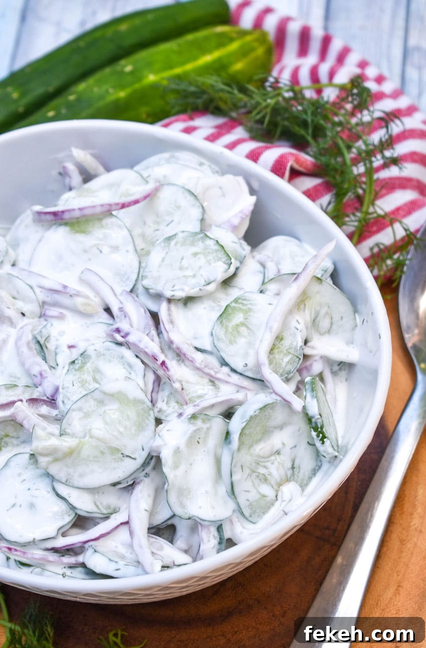 Creamy Cucumber Salad Recipe with Dill and Sour Cream 3 creamy cucumber salad in a white serving bowl