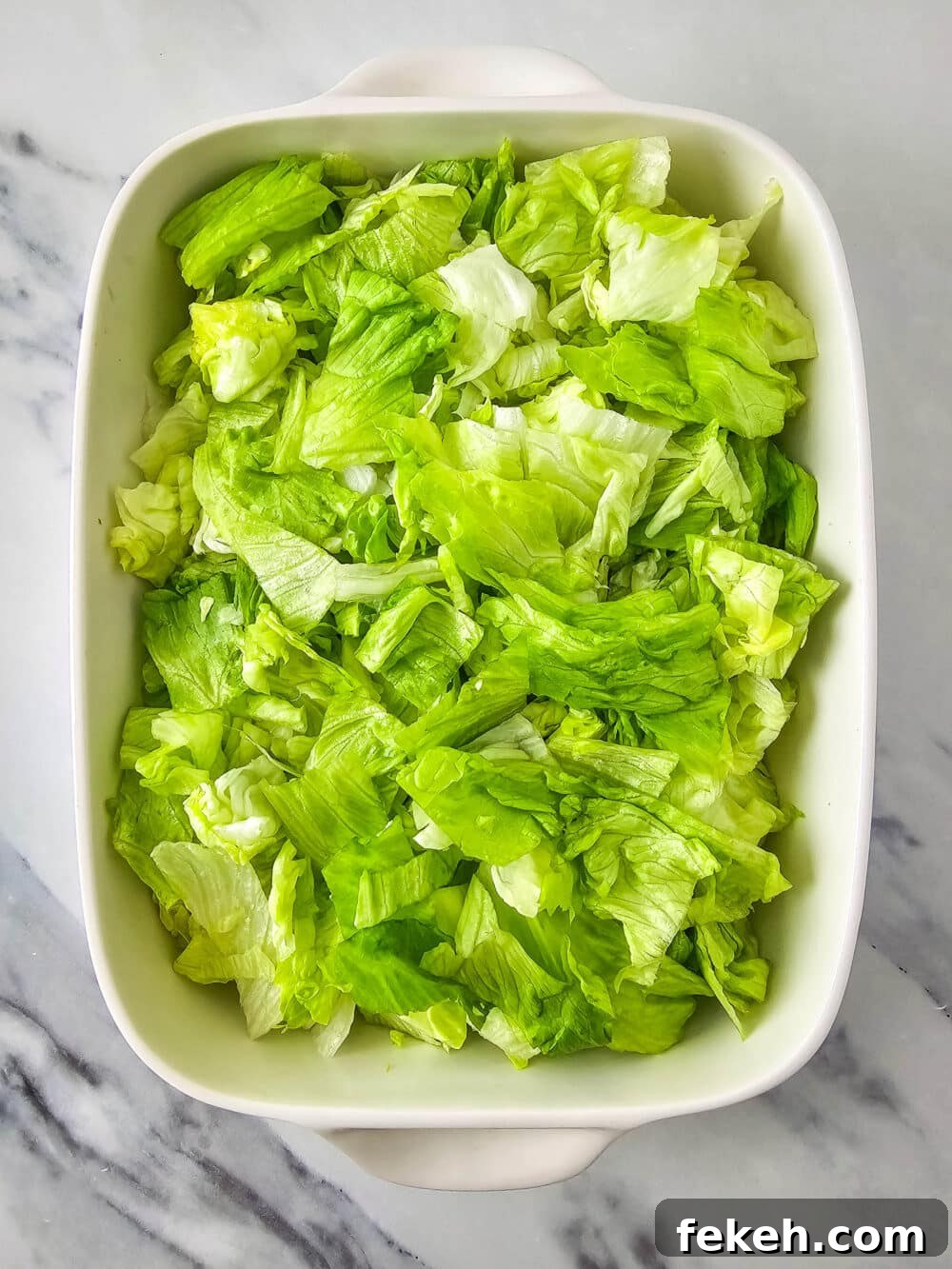 Keto Big Mac Salad: High-Protein Low-Carb Cheeseburger Bowl 8 chopped lettuce in a casserole dish