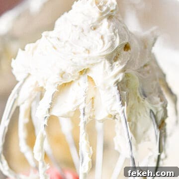 Cream Cheese Frosting Recipe: Smooth, Tangy, Ready in Minutes 6 The 3 ingredient cream cheese frosting is on a wire whisk attachment.