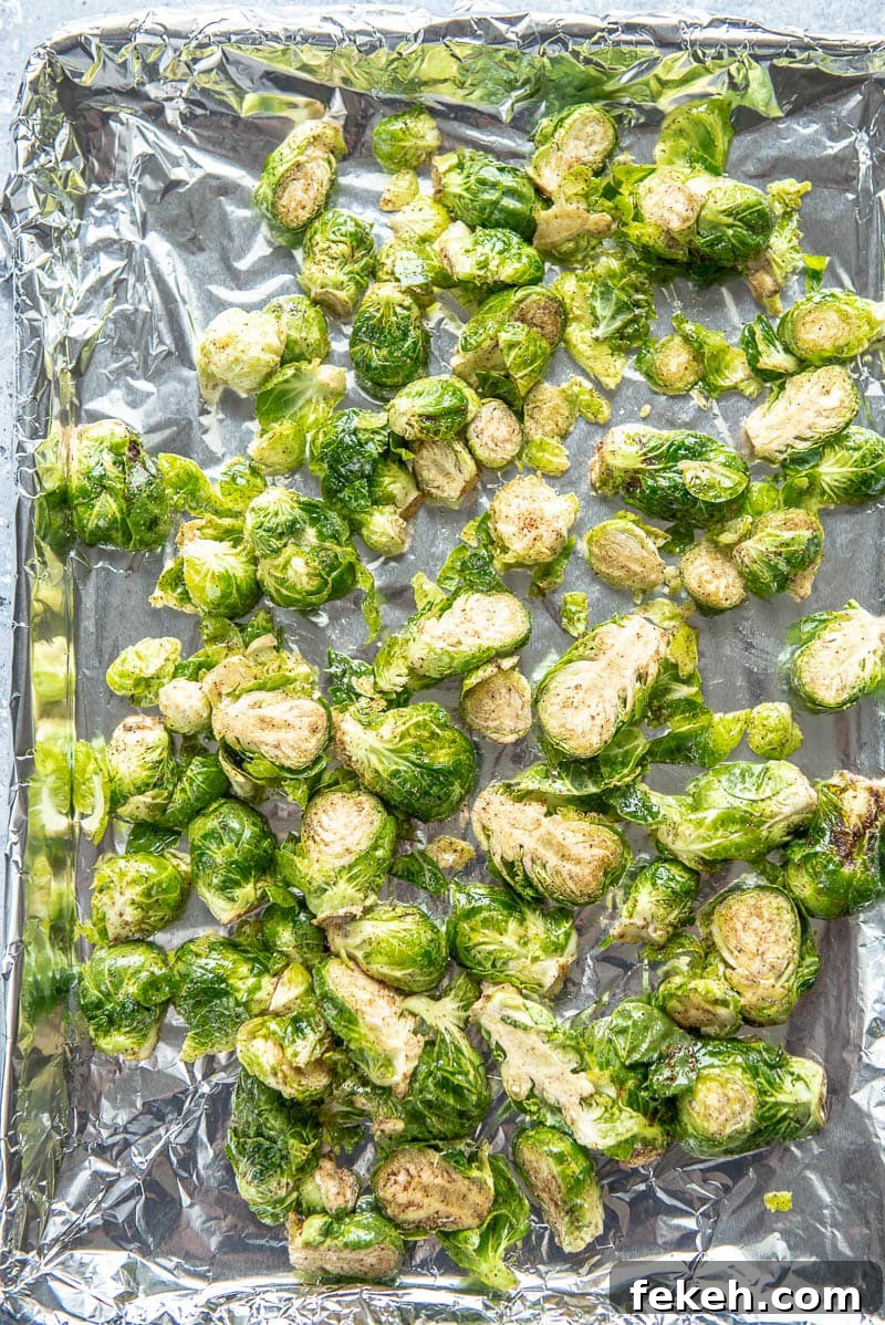 Crispy Spicy Brussels Sprouts with Garlic and Chili 5 seasoned brussels sprouts on a baking sheet