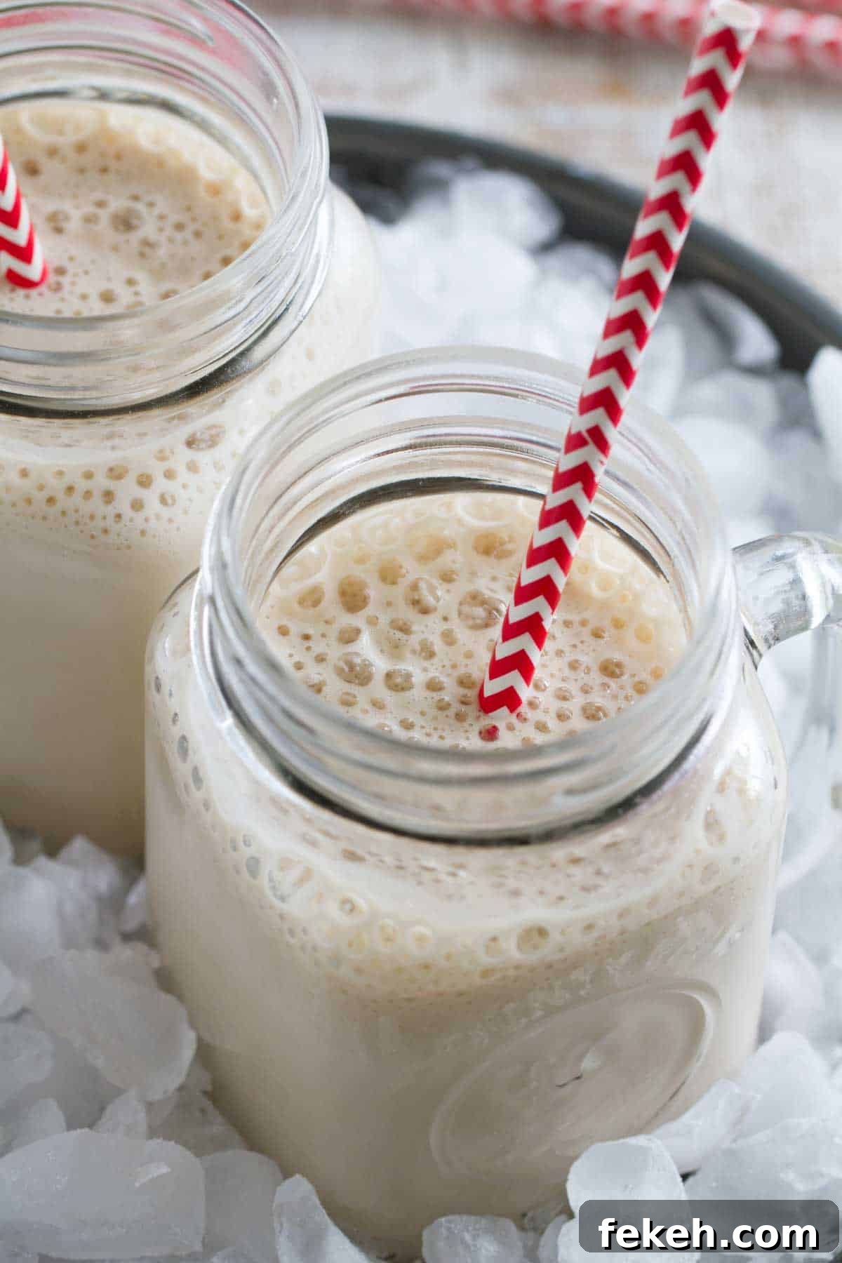 Root Beer Float Smoothie Recipe — Creamy Soda Dessert Drink 3 Two root beer float smoothies in ice.