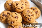 large pumpkin chocolate chip cookies on a white plate