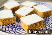 A dark blue and white plate with six pumpkin squares.