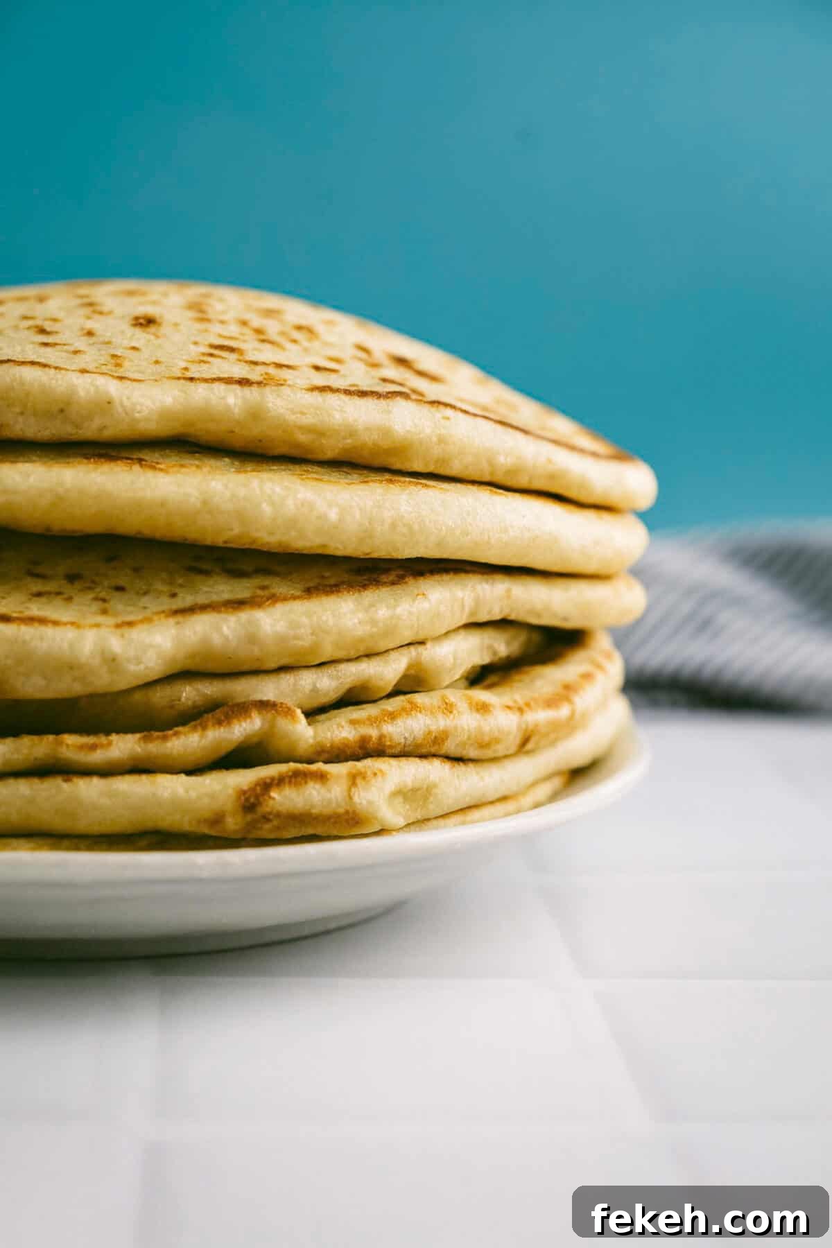 Authentic Greek Pita Bread Recipe: Soft, Foldable Pitas 2 Stack of soft Greek pita bread showing thickness and texture.