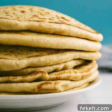 Authentic Greek Pita Bread Recipe: Soft, Foldable Pitas 14 Close-up of Greek pita bread with soft layers and golden surface.
