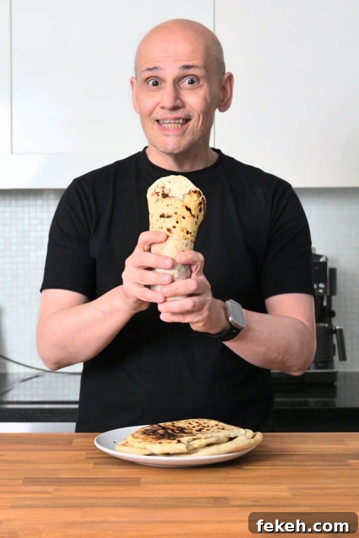 Authentic Greek Pita Bread Recipe: Soft, Foldable Pitas 3 PeterG (owner of Souvlaki For The Soul) holding a handmade wrapped greek pita bread.