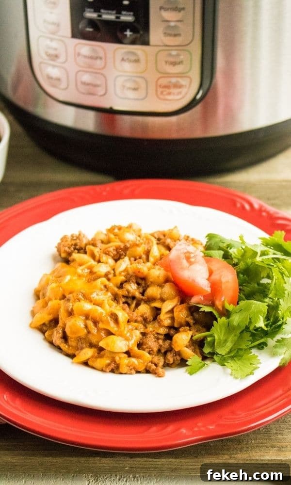 plate with taco pasta with instant pot behind it