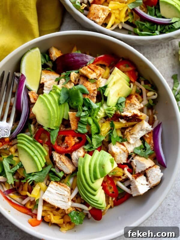Creative Pizza Bowl Recipes: Flavorful Mini Pizza Bowls for Any Meal 10 Two grey bowls with thai mango salad and a fork in the bowl on the table.