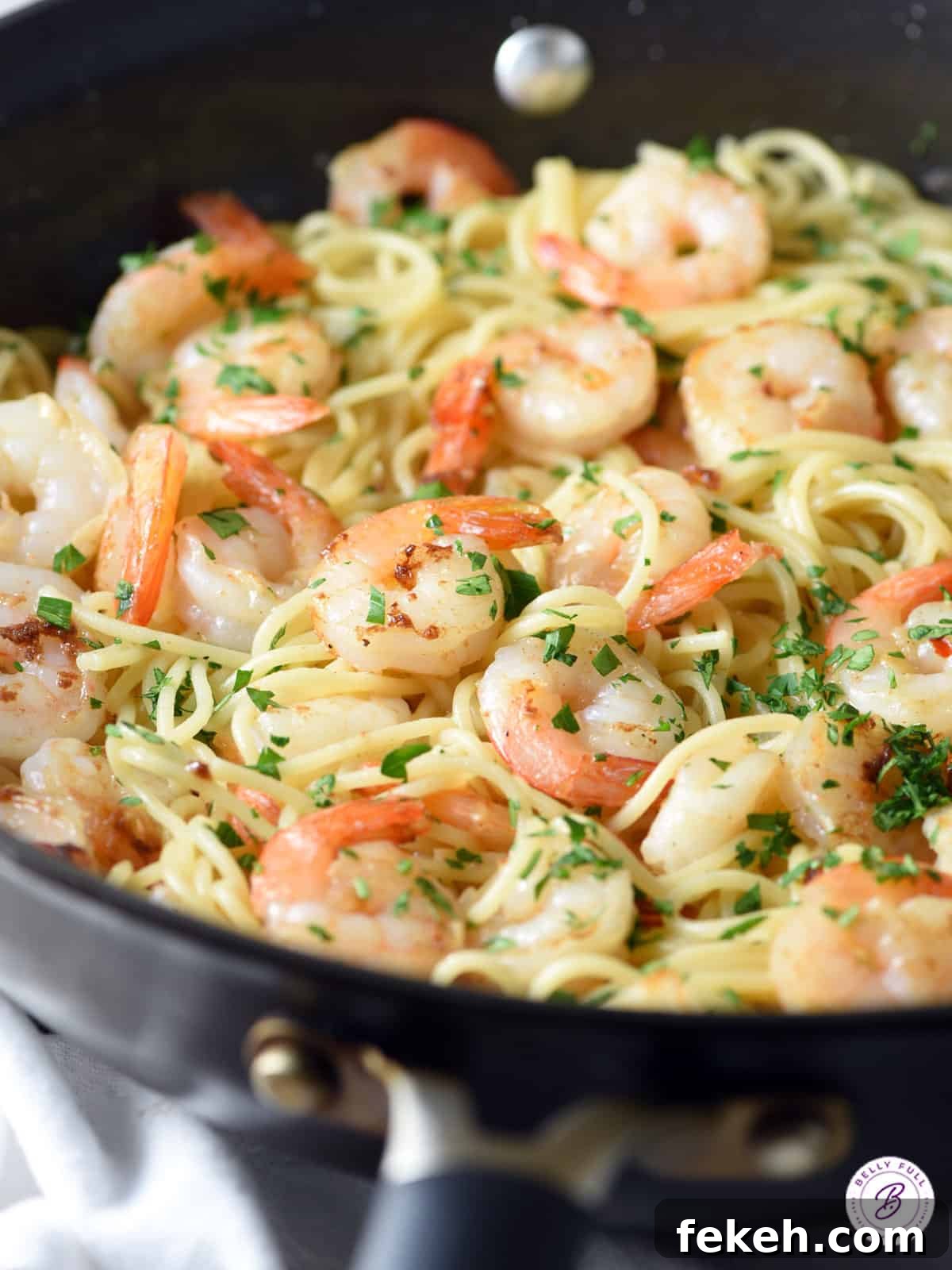 Orange-Balsamic Shrimp Pasta with Garlic and Parmesan 2 cooked shrimp and spaghetti pasta in skillet