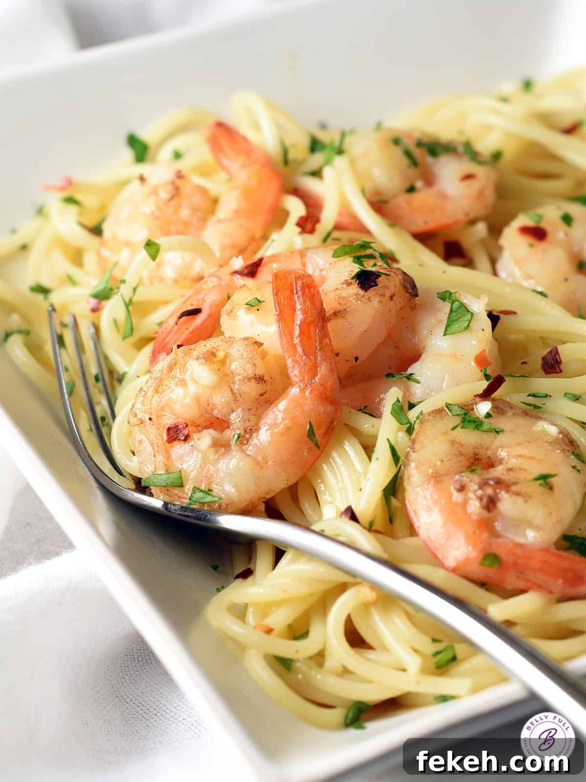 Orange-Balsamic Shrimp Pasta with Garlic and Parmesan 3 cooked shrimp with tail on over a bed of spaghetti