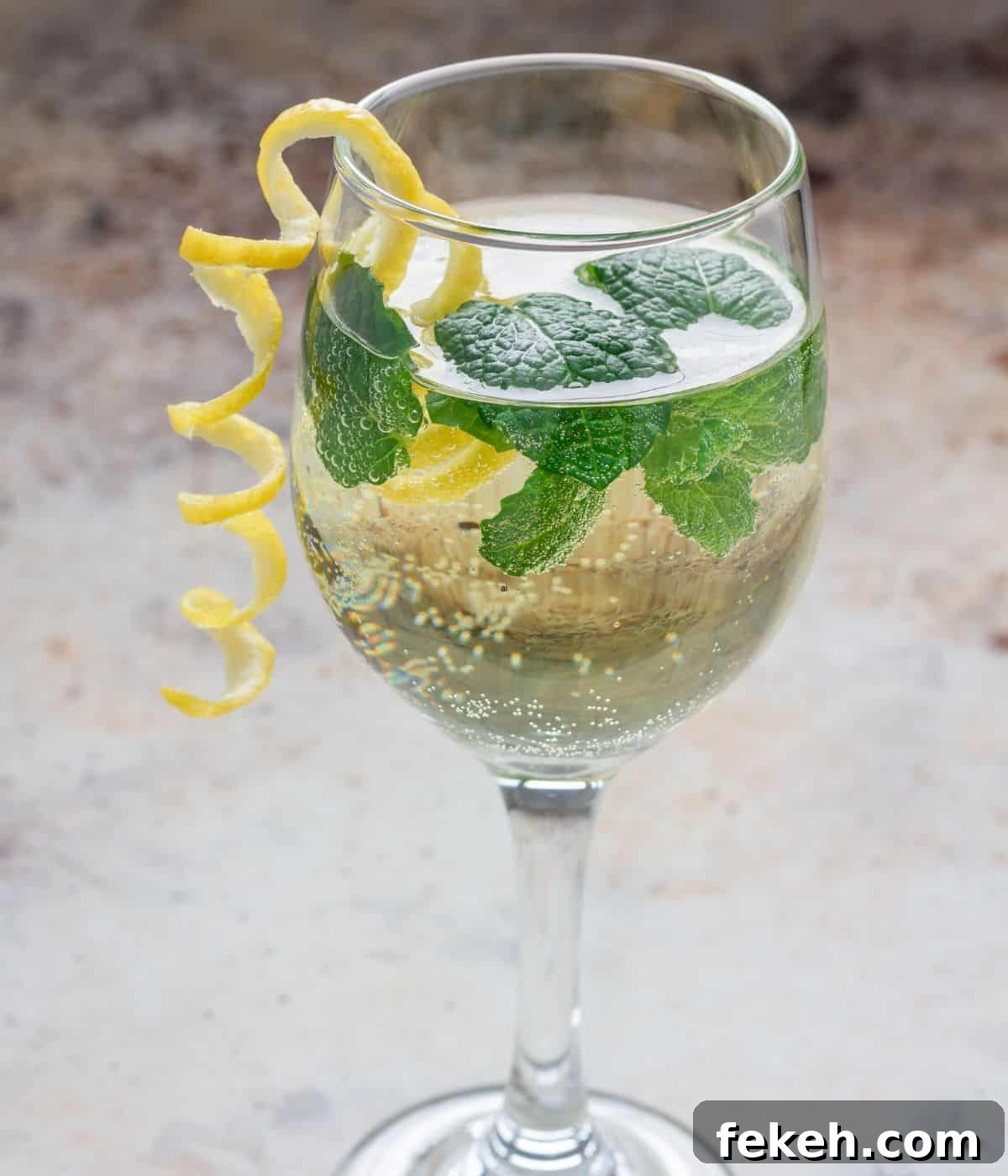 22 Elegant Cocktail Recipes for Sophisticated Events 7 White wine spritzer on table.