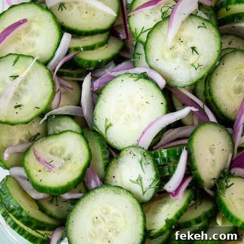 overhead view of cucumber salad with onions ready to serve