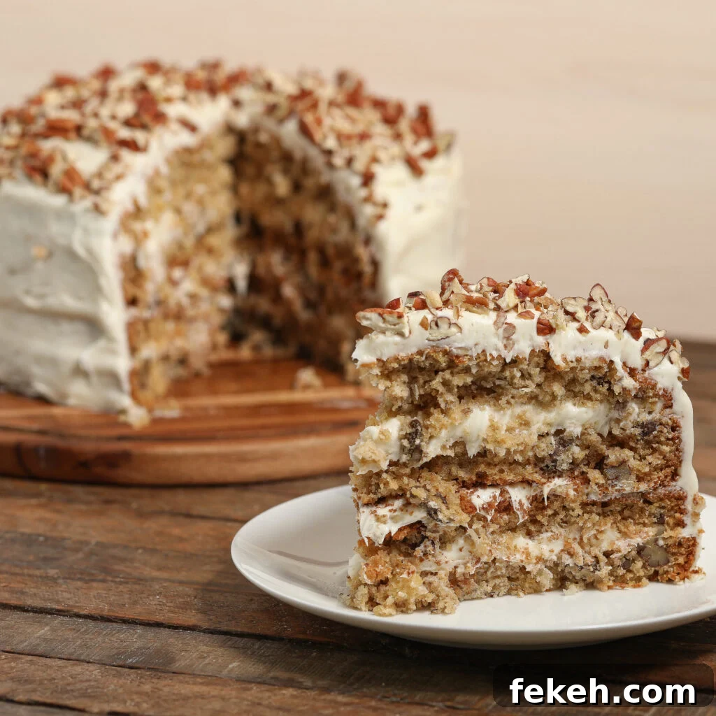 44 Gluten-Free Dairy-Free Cake Recipes for Every Occasion 2 A slice of layered hummingbird cake with white frosting and chopped nuts sits on a plate, while the rest of the cake, also frosted and topped with nuts, is in the background on a wooden board.