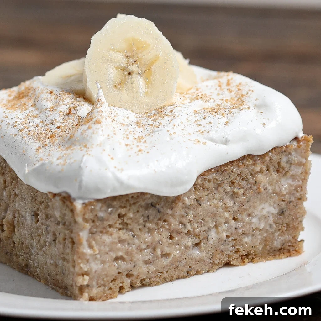 44 Gluten-Free Dairy-Free Cake Recipes for Every Occasion 31 A slice of Banana Tres Leches Cake topped with a thick layer of whipped cream, banana slices, and a sprinkle of cinnamon, served on a white plate.