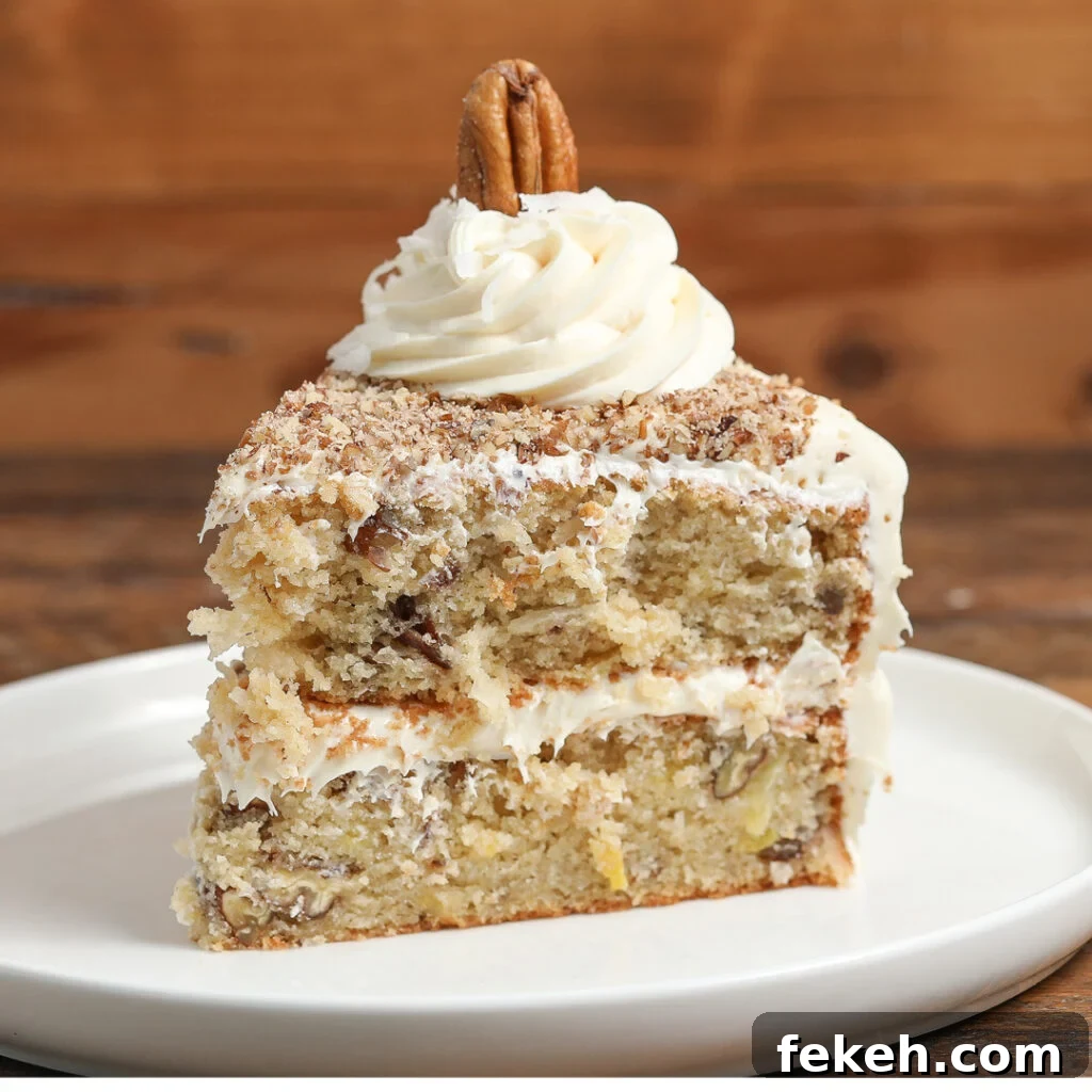 44 Gluten-Free Dairy-Free Cake Recipes for Every Occasion 5 A slice of Italian cream cake with white frosting, topped with a swirl of frosting and a whole pecan, served on a white plate against a wooden background.