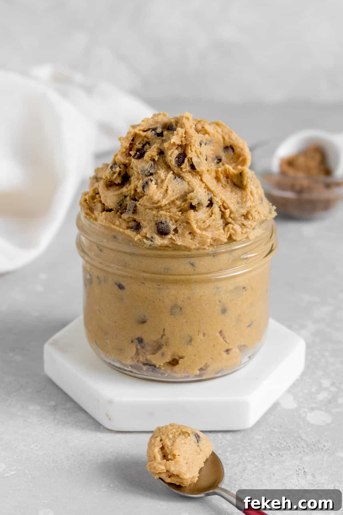 Safe-to-Eat Chocolate Chip Cookie Dough Recipe 2 A jar overflowing with edible chocolate chip cookie dough.