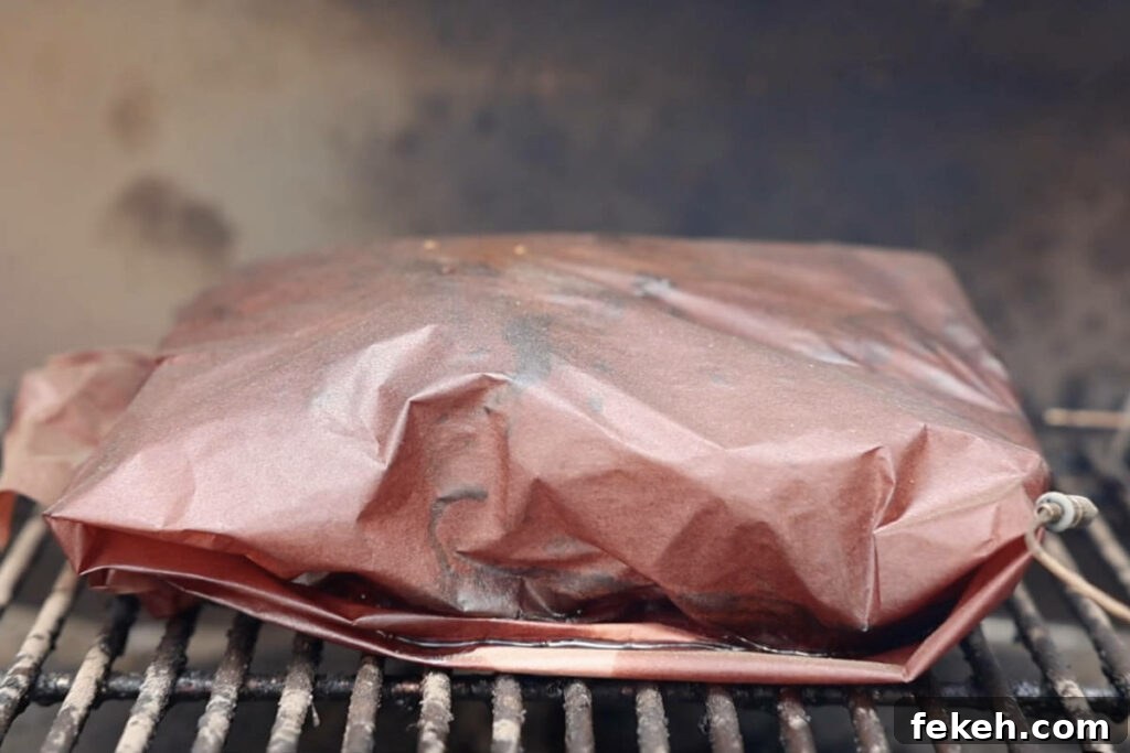 Smoked Pork Butt (Smoked Pork Shoulder) Recipe for Tender, Juicy Meat 11 Wrapped pork butt on the smoker.