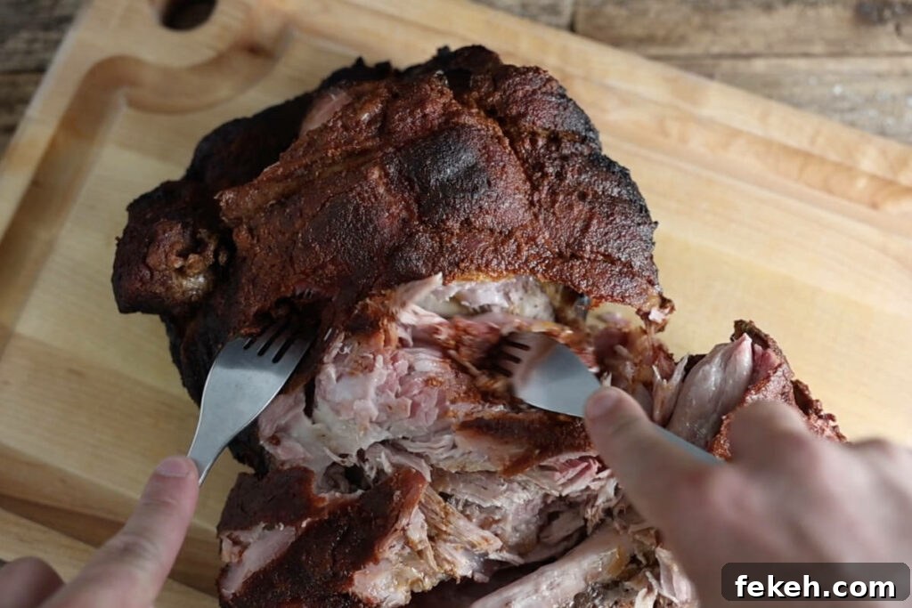 Smoked Pork Butt (Smoked Pork Shoulder) Recipe for Tender, Juicy Meat 13 Pulling apart pork butt.