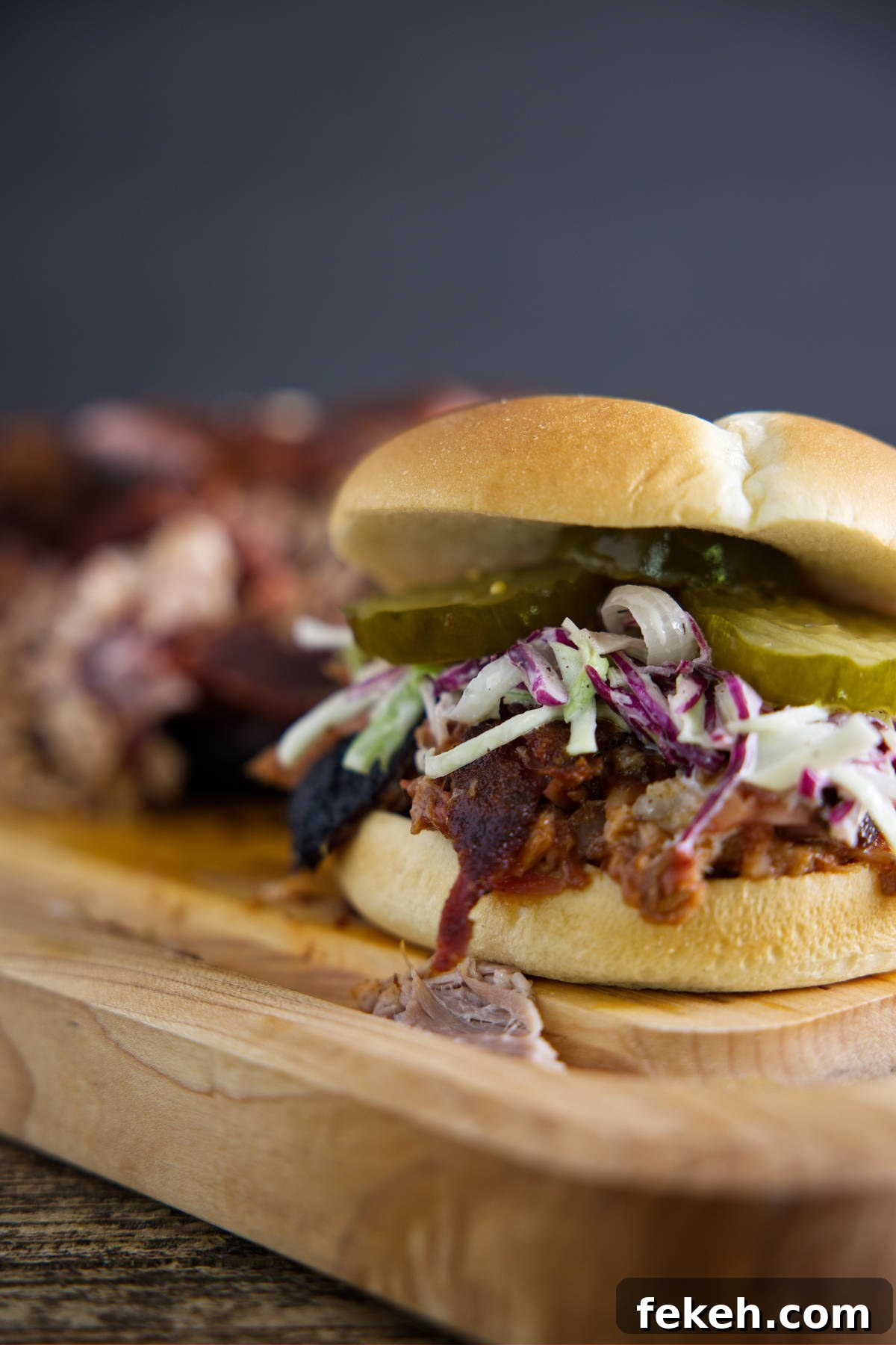 Smoked Pork Butt (Smoked Pork Shoulder) Recipe for Tender, Juicy Meat 19 Pulled pork sandwich on butcher block.