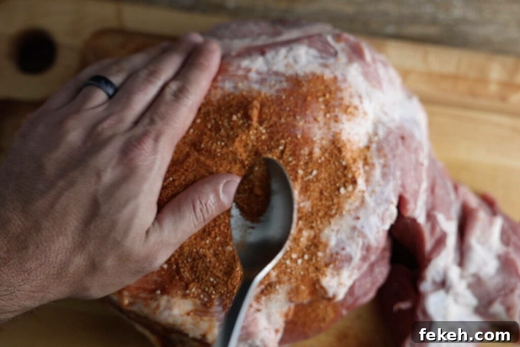 Smoked Pork Butt (Smoked Pork Shoulder) Recipe for Tender, Juicy Meat 6 Rubbing pork butt with dry pork butt rub.