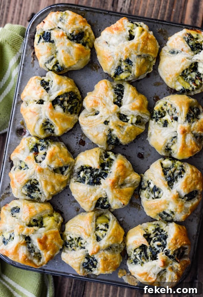Spinach Puff Pastry Bites: Flaky Savory Appetizer Recipe 6 Spinach and Feta Puff Pastry Appetizers in mini muffin tins. A green and white striped napkin sits next to it.